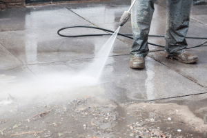 Pressure washing services Lakeland - man pressure washing a driveway