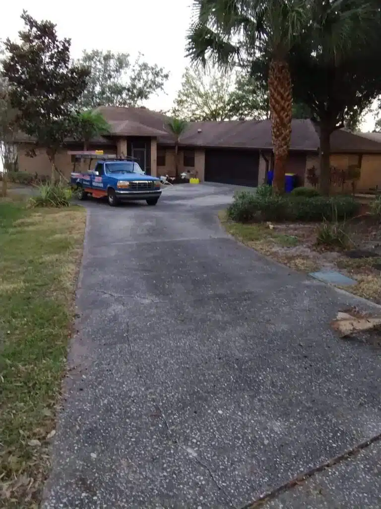 House with blue truck in driveway