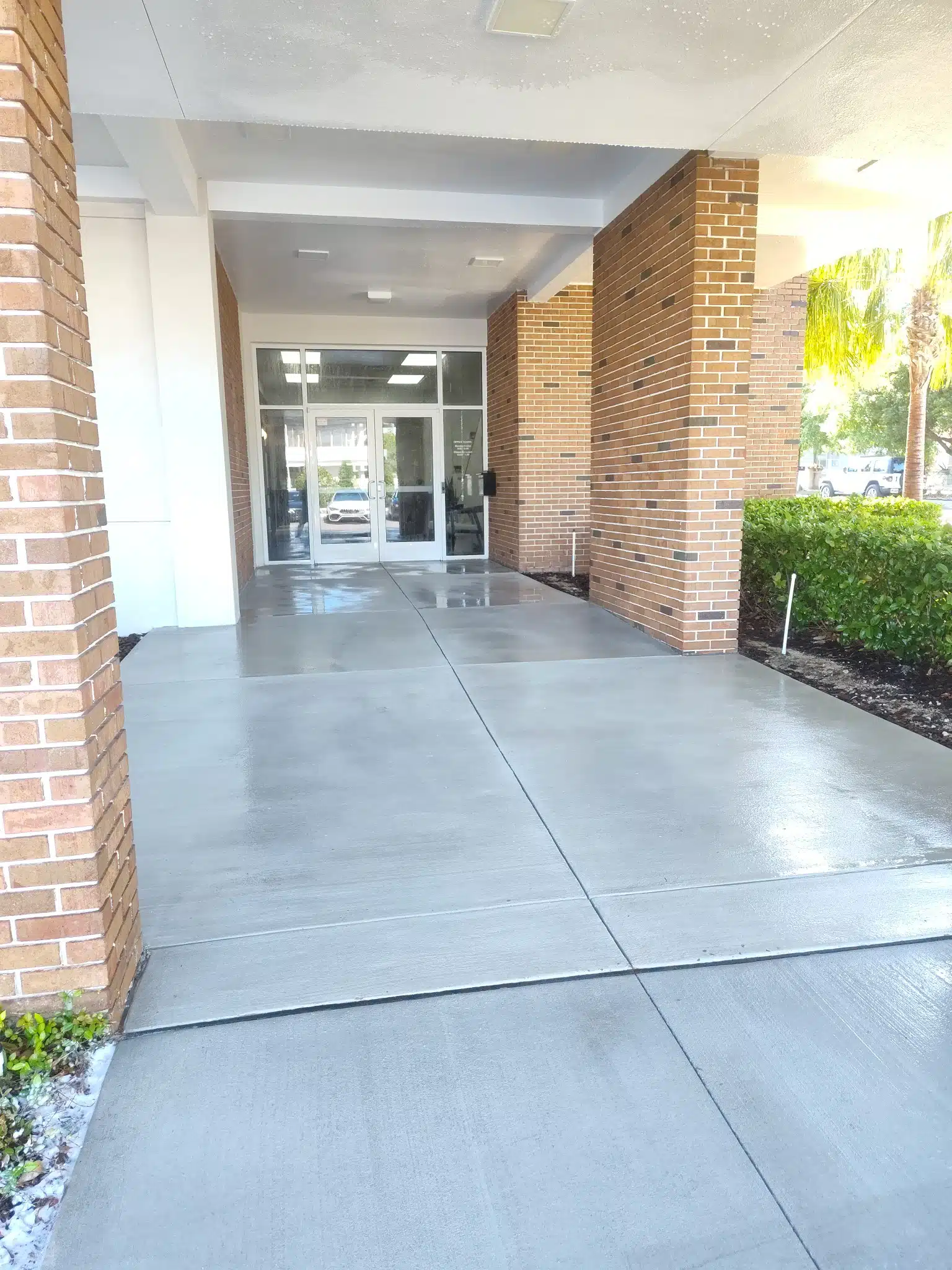 Entrance with glass doors and brick columns